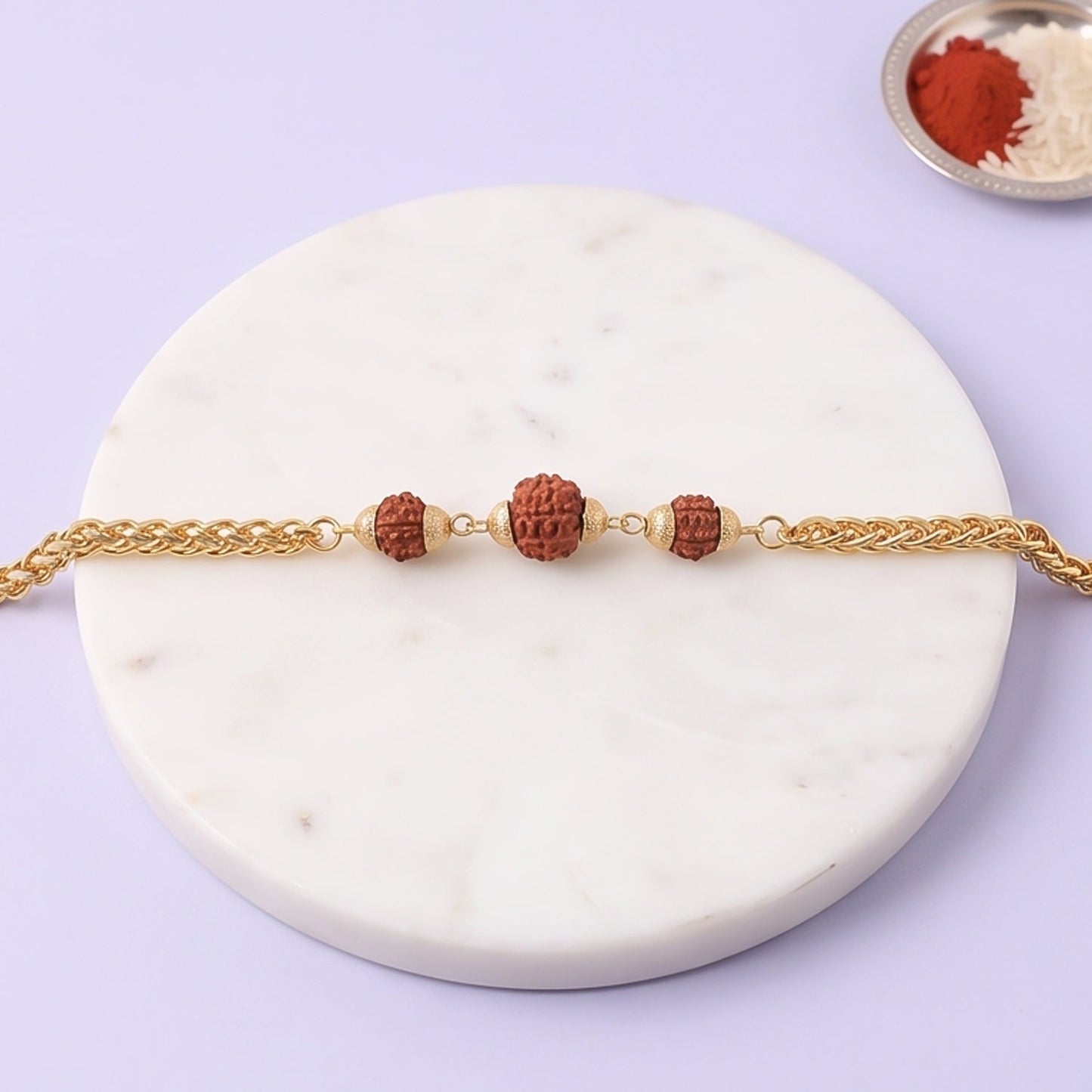 Gold-plated Rudraksha bead Rakhi with chain design, perfect for brothers, featuring intricate details and traditional craftsmanship.