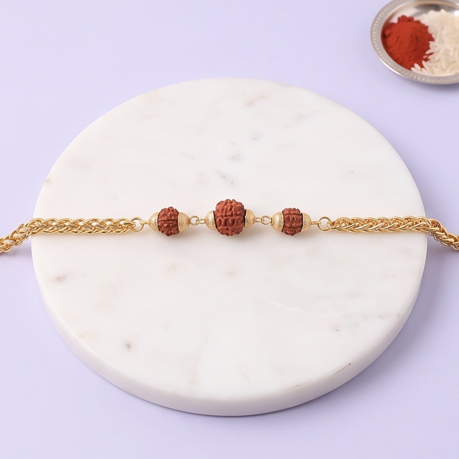 Gold-plated Rudraksha bead Rakhi with chain design, perfect for brothers, featuring intricate details and traditional craftsmanship.