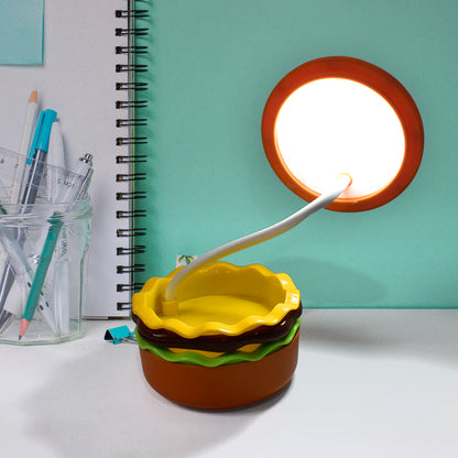Wukusy Burger Delight folding LED night lamp, shaped like a burger, glowing softly with adjustable brightness in a cozy room setting.