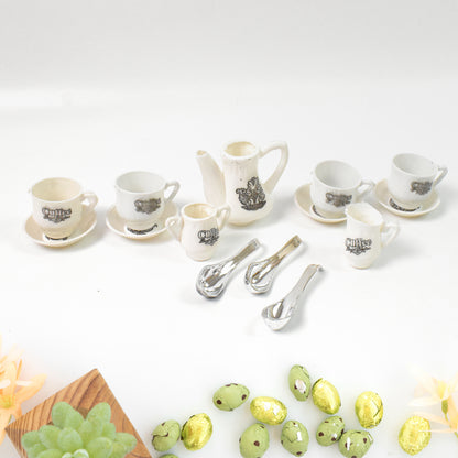 Wukusy Tickles Tea Toy Set with 14 plastic coffee kitchen accessories for kids, boys, and girls, arranged on a wooden surface.