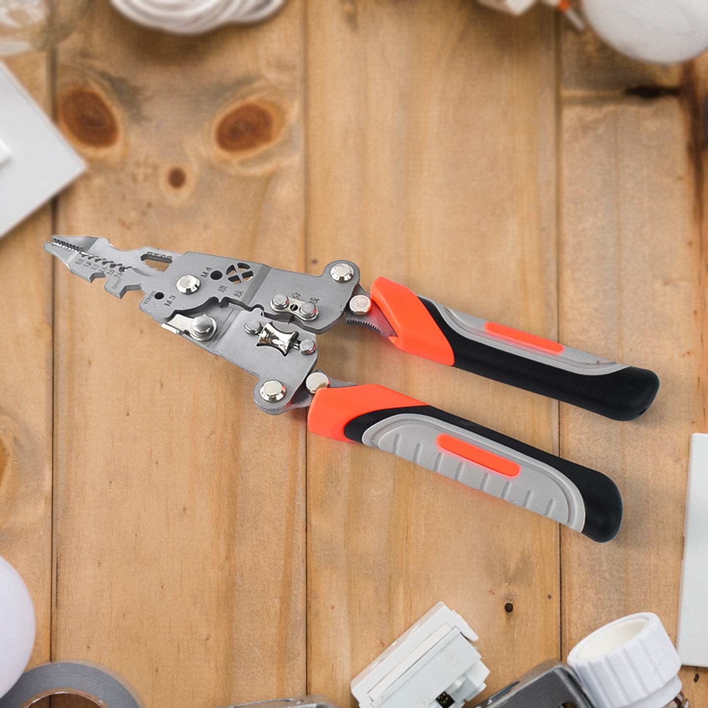 Wukusy 8-in-1 wire stripper pliers with soft grip handles, showing the tool with multiple stripping functions and ergonomic design.
