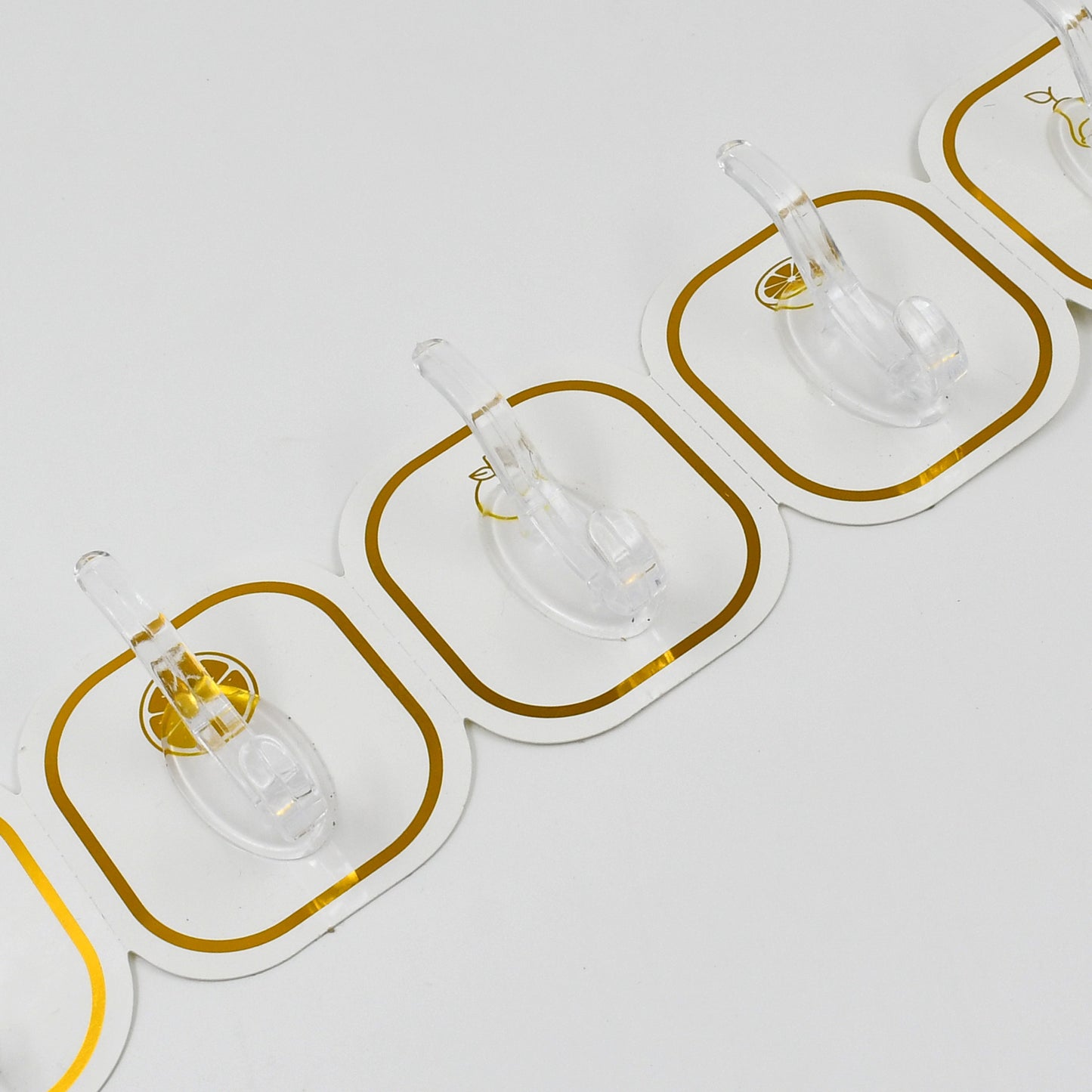 Six transparent Wukusy adhesive wall hooks attached to a wall for home organization and hanging items.