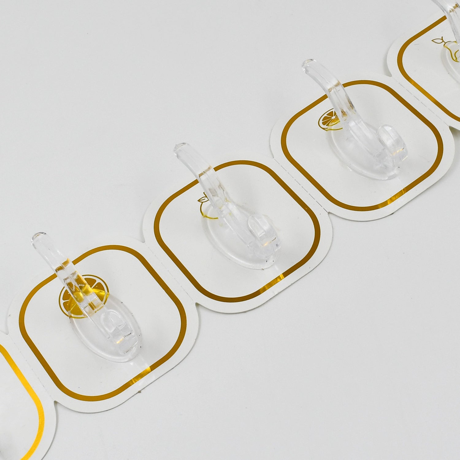 Six transparent Wukusy adhesive wall hooks attached to a wall for home organization and hanging items.