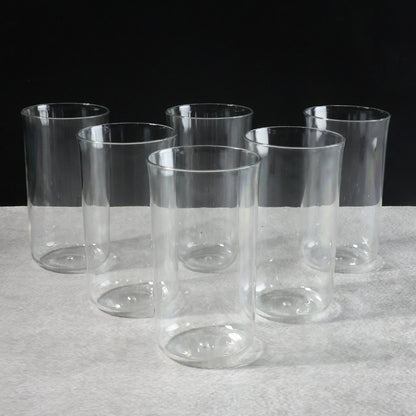 Six glossy plastic drinking glasses by Wukusy, 300 ml each, arranged on a kitchen countertop for home use.