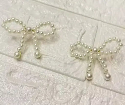 Ekom Pearl Knot Bow Dangle Earrings with elegant pearl and bow design, fashion jewelry for stylish occasions.