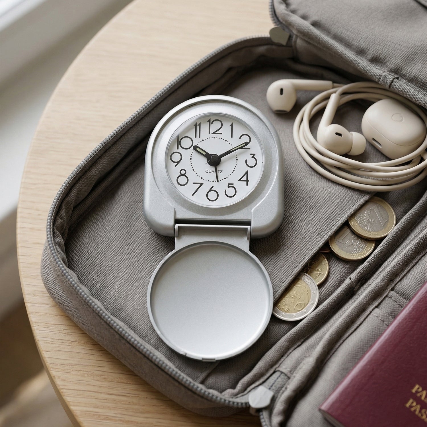 Wukusy compact foldable travel alarm clock with digital display, black plastic case, and foldable stand for portability.
