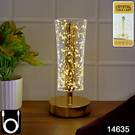 Luxury golden crystal LED table lamp by Wukusy with a sleek base and shimmering crystal accents, illuminated in a modern home setting.