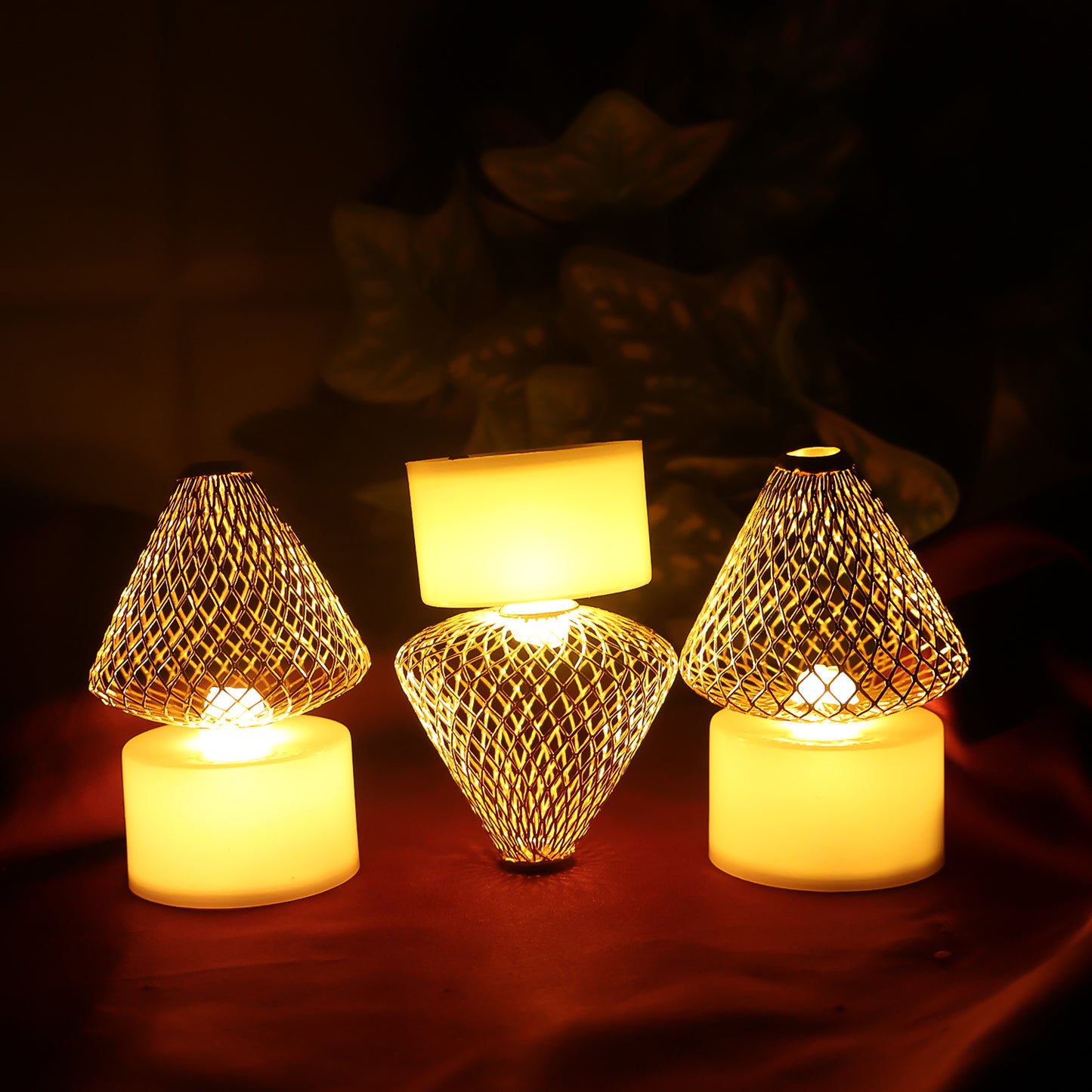 Set of 12 decorative LED flameless candle lights with golden net covers for home decor, arranged in a cozy display.