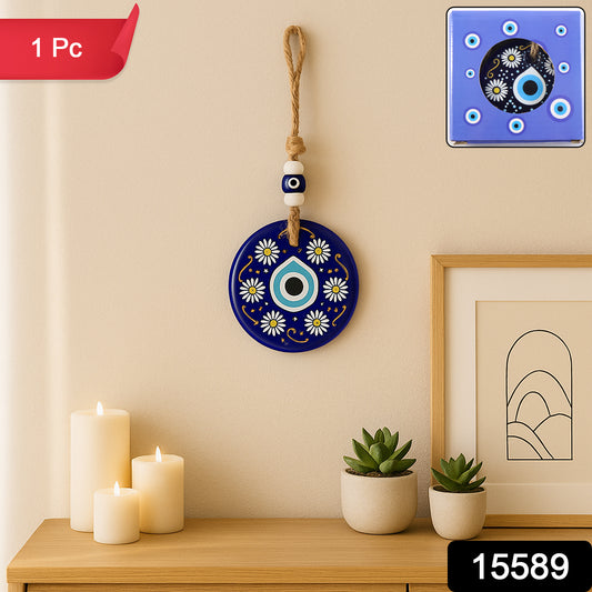 Decorative evil eye wall hanging Nazar protector charm with beads, wind chime, from Wukusy, hanging on a wall.