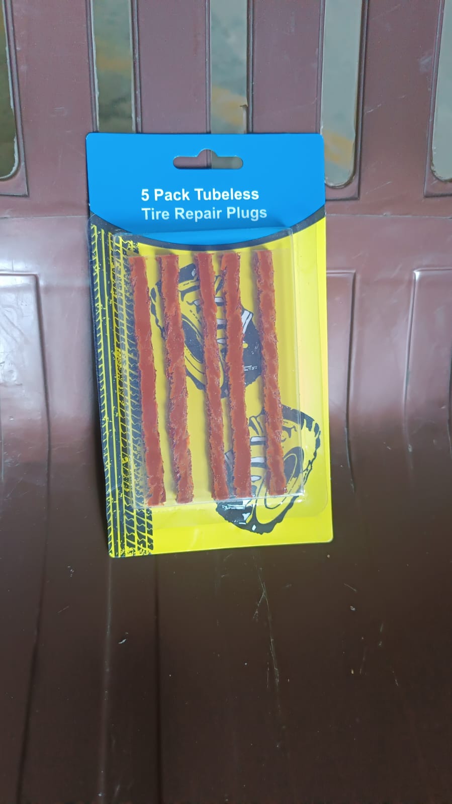 Set of five Wukusy brown tyre repair emergency puncture seal strips laid out for quick repair on vehicle tyres.
