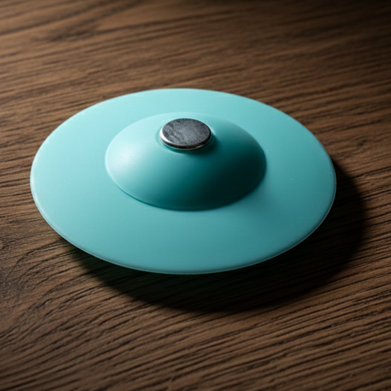 Flexible silicone sink drain cover and hair catcher strainer by Wukusy, showing a close-up of the black drain cover in use.