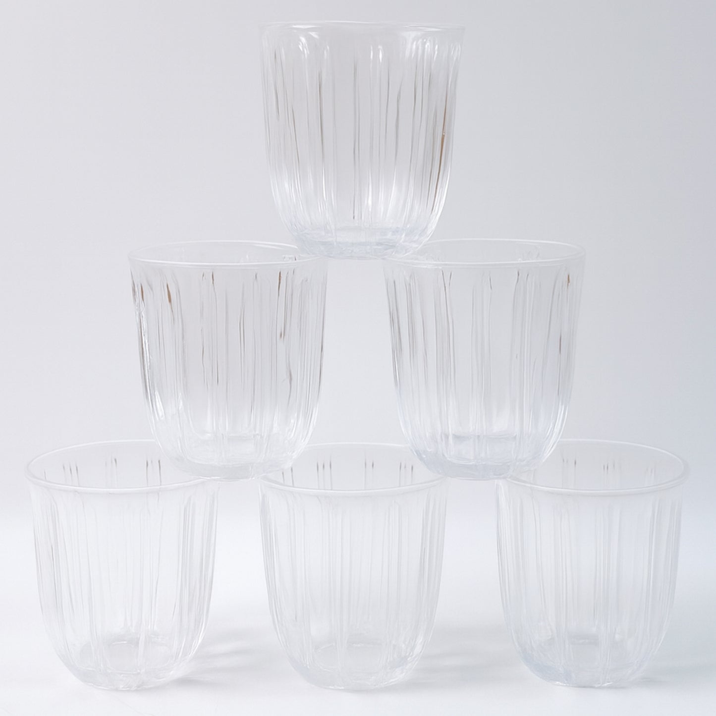 Six transparent glass tumblers from Wukusy's premium 256ml set, ideal for beverages in home and kitchen use.