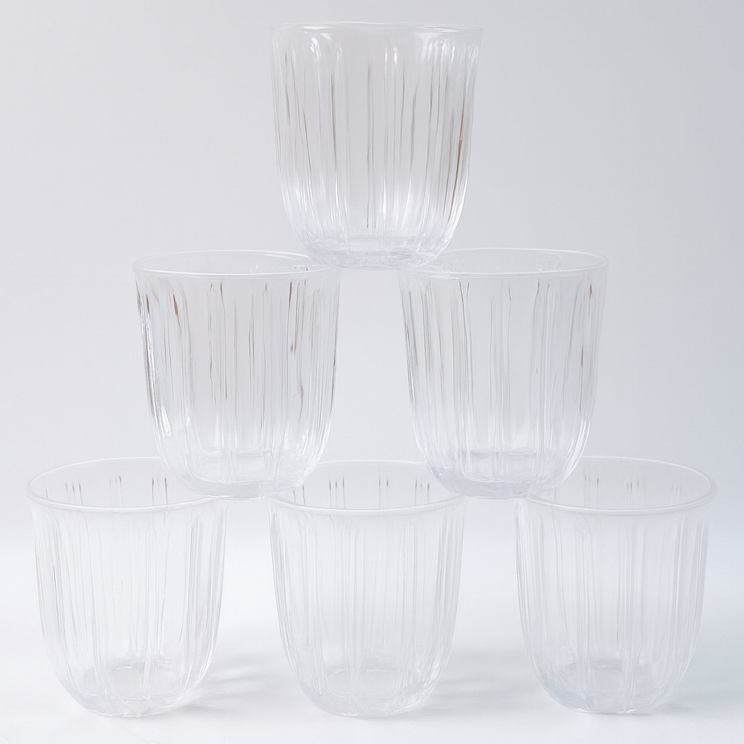 Six transparent glass tumblers from Wukusy's premium 256ml set, ideal for beverages in home and kitchen use.