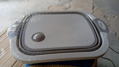 Wukusy collapsible cutting board with integrated dish tub basket, compact and space-saving for home and kitchen use.