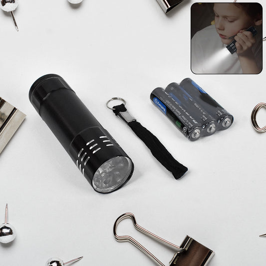 Portable Wukusy mini torch with bright LED light, battery-operated travel flashlight, 3AAA batteries included, compact and easy to carry.
