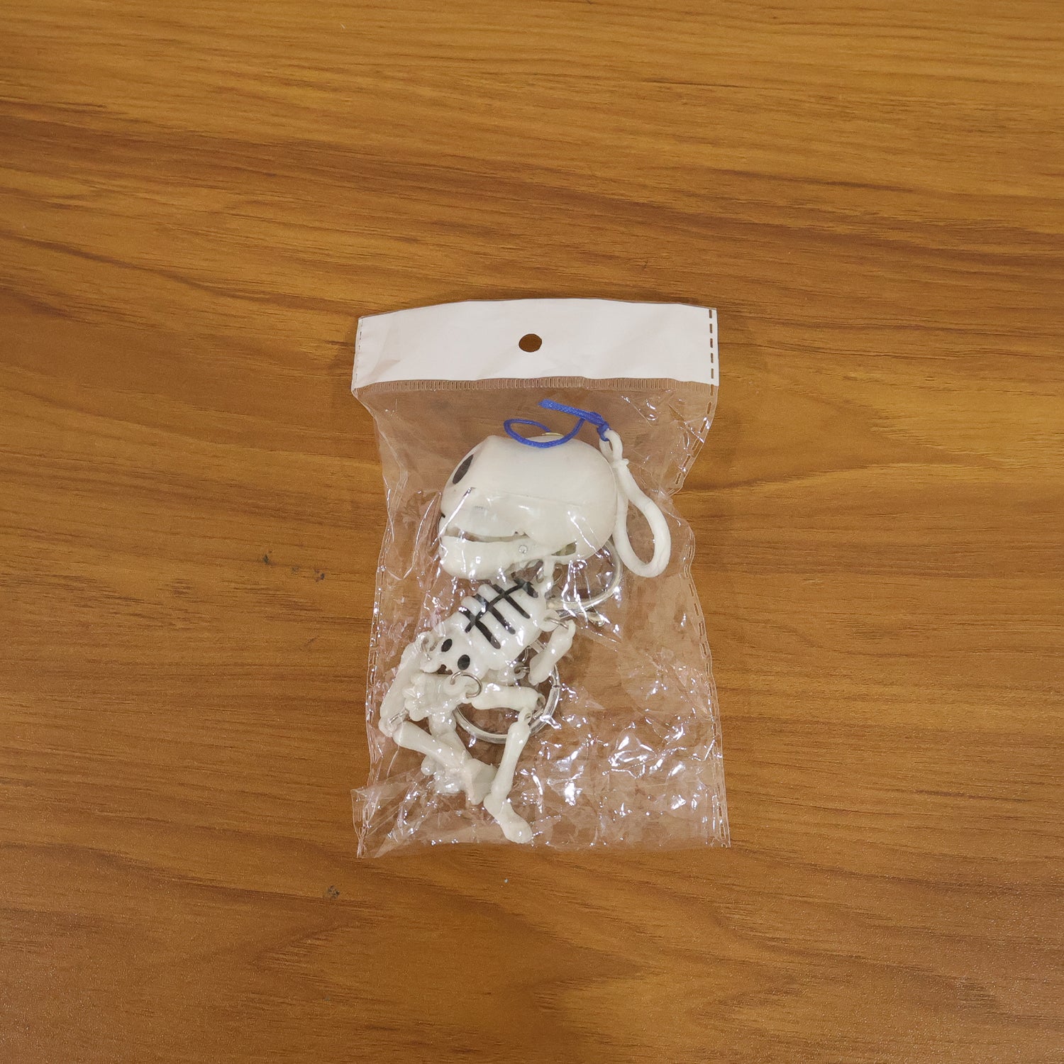 Two Wukusy skeleton doll keychains with metal hooks, featuring detailed bone designs on a white background.