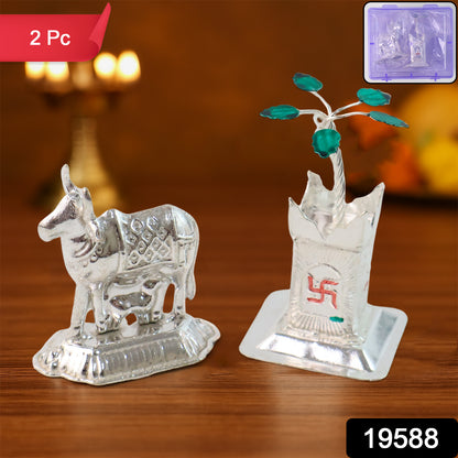 Silver-plated Kamdhenu Cow and Tulsi plant pair for pooja and home decor, displayed on a decorative stand.