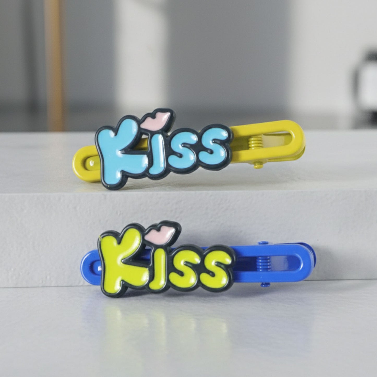 Wukusy Cute Kiss Text Hair Clip Set with two petite hair accessories featuring black and white kiss design, perfect for styling.