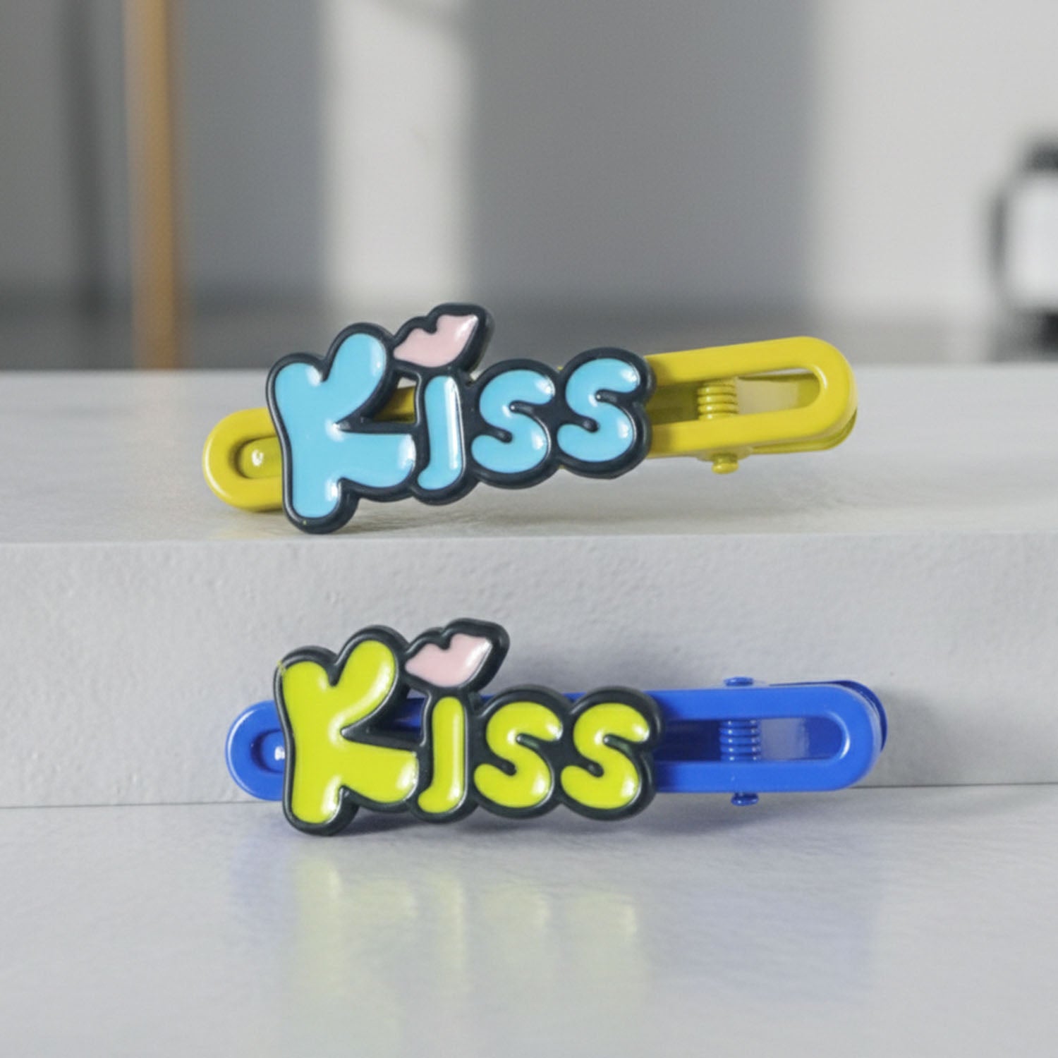 Wukusy Cute Kiss Text Hair Clip Set with two petite hair accessories featuring black and white kiss design, perfect for styling.