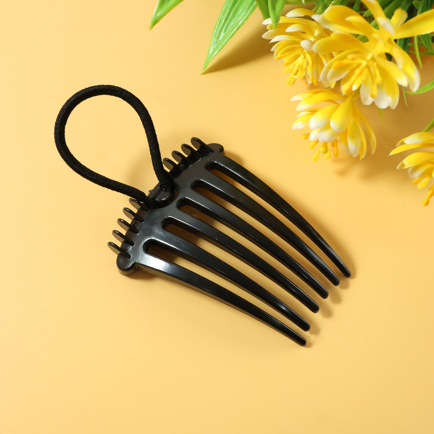 Wukusy volumizing hair bun comb clip holding a styled bun for a natural, full look with a sleek black design.