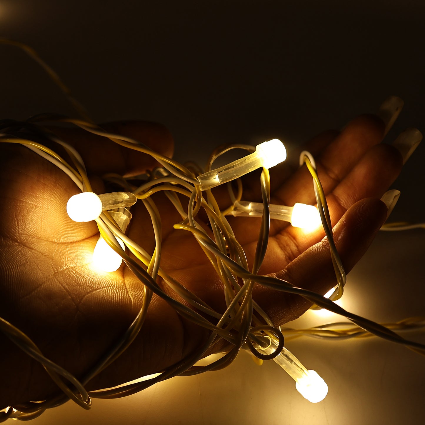 Wukusy LED decorative string fairy lights, 10 meters long, perfect for home decor with warm glowing bulbs on a flexible wire.