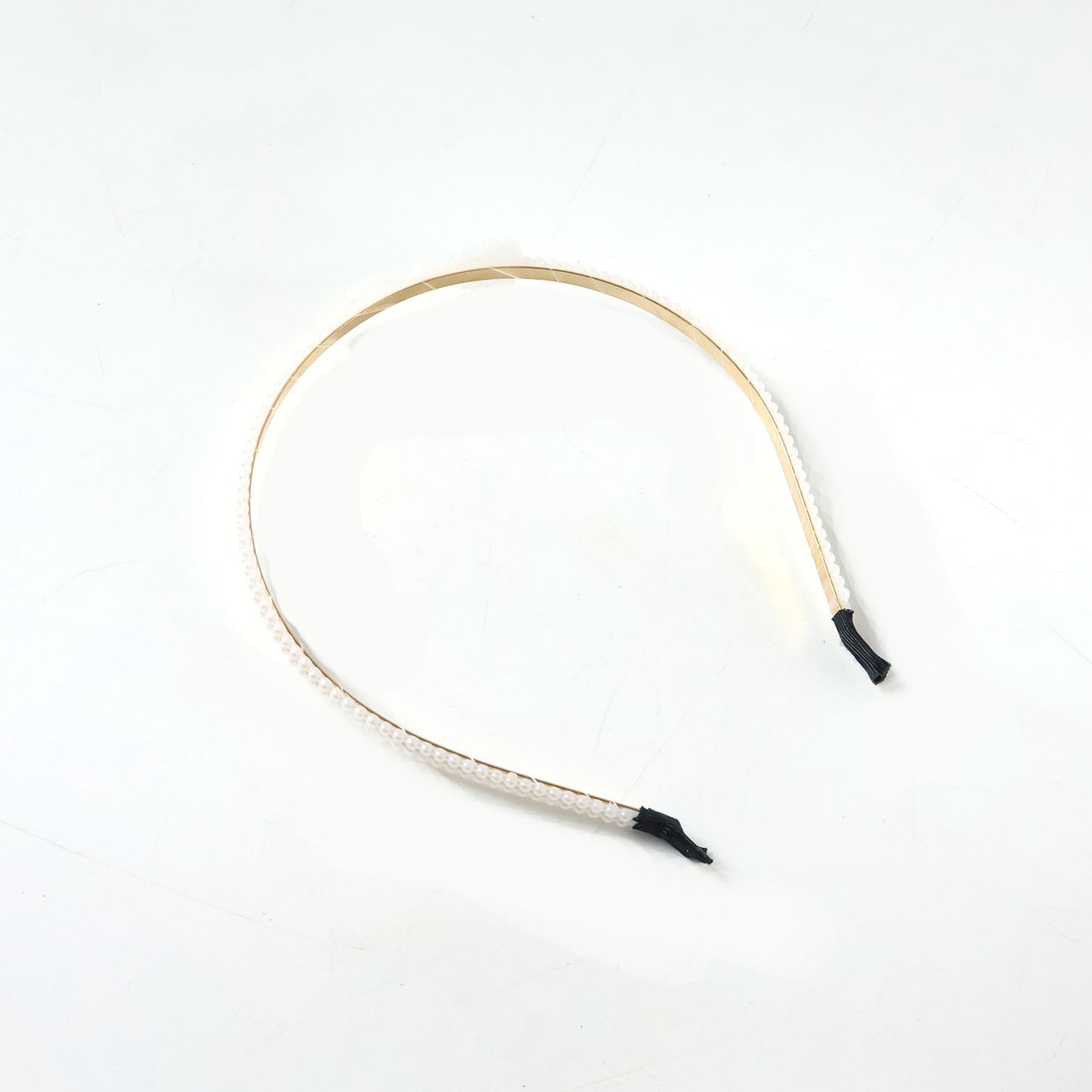 Elegant pearl beaded slim metal hair band by Wukusy with delicate pearl accents and a sleek metal design.