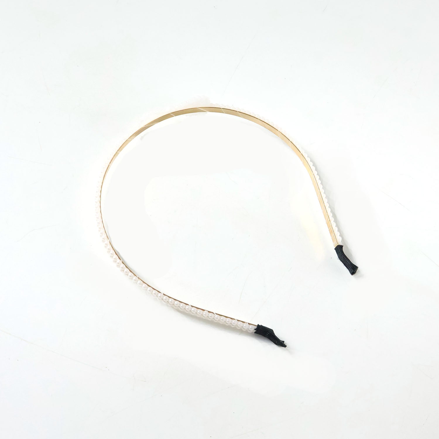 Elegant pearl beaded slim metal hair band by Wukusy with delicate pearl accents and a sleek metal design.