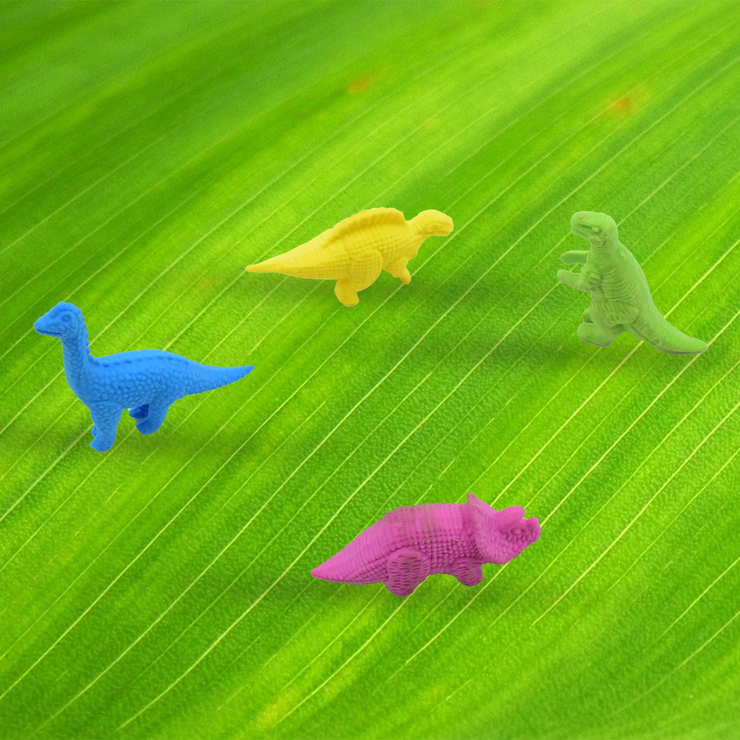 Set of four Wukusy small dinosaur-shaped erasers, colorful 3D animal erasers for kids, desk toys, and school stationery.