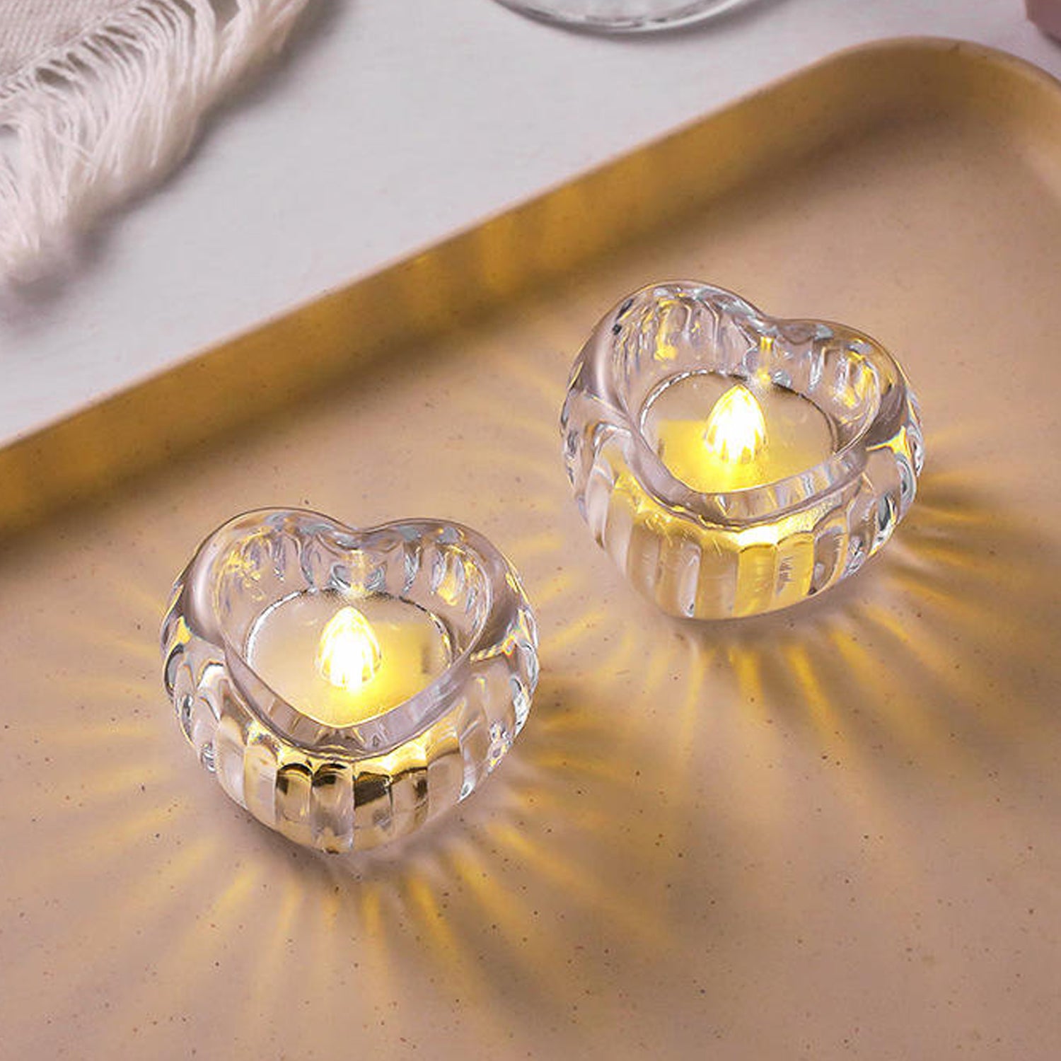 Set of 12 Wukusy heart-shaped LED flameless decorative candles with warm glow for romantic or ambient decor.