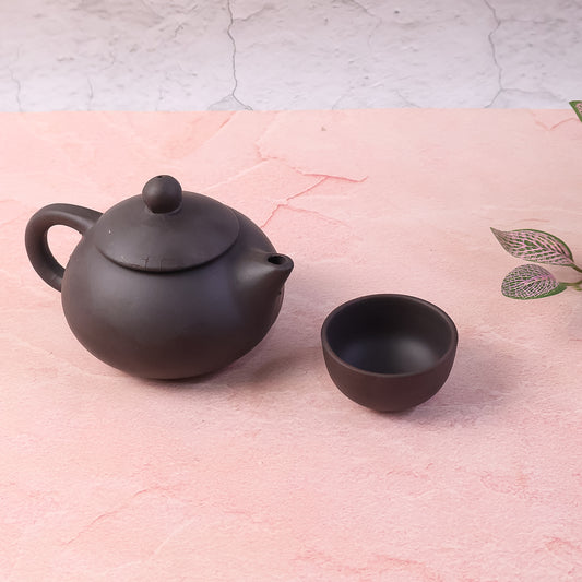 Black clay ceramic tea set with teapot and four cups by Wukusy, perfect for home tea brewing and serving.