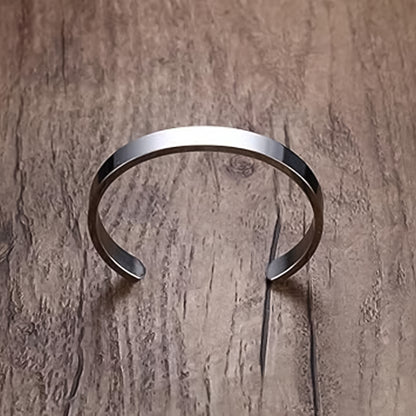 Silver-tone stainless steel minimalist open-ended kada bracelet by Wukusy, polished fashion accessory with sleek, modern design.