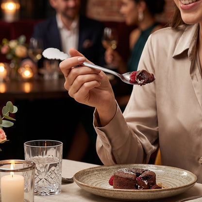 Wukusy stainless steel carved handle dinner spoon with intricate design, ideal for dining and kitchen use.