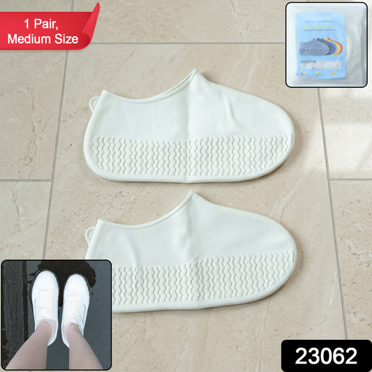 Pair of white waterproof silicone shoe covers by Wukusy, medium size, shown protecting shoes against rain and moisture.