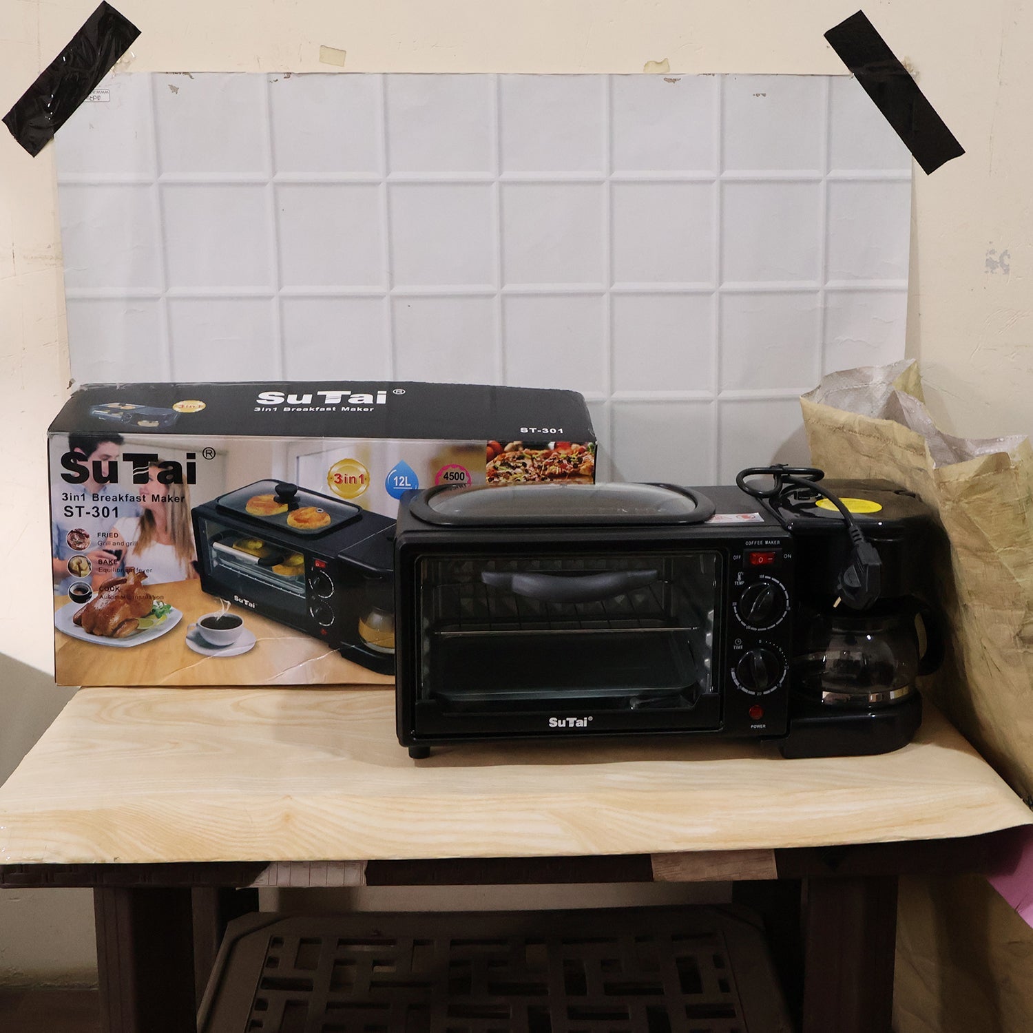 Wukusy Suta 3-in-1 breakfast maker with compact design, featuring a toaster, coffee maker, and egg cooker in a modern kitchen setting.
