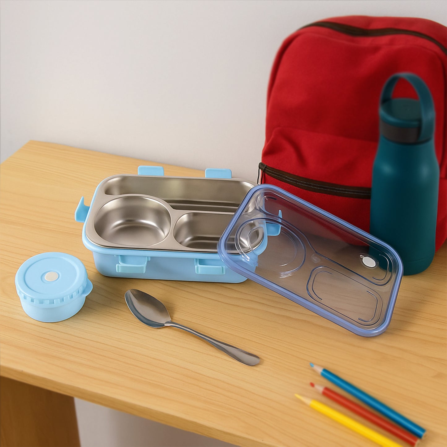 Stainless steel compartment lunch box set by Wukusy with multiple sections for organized meal storage in a home and kitchen setting.