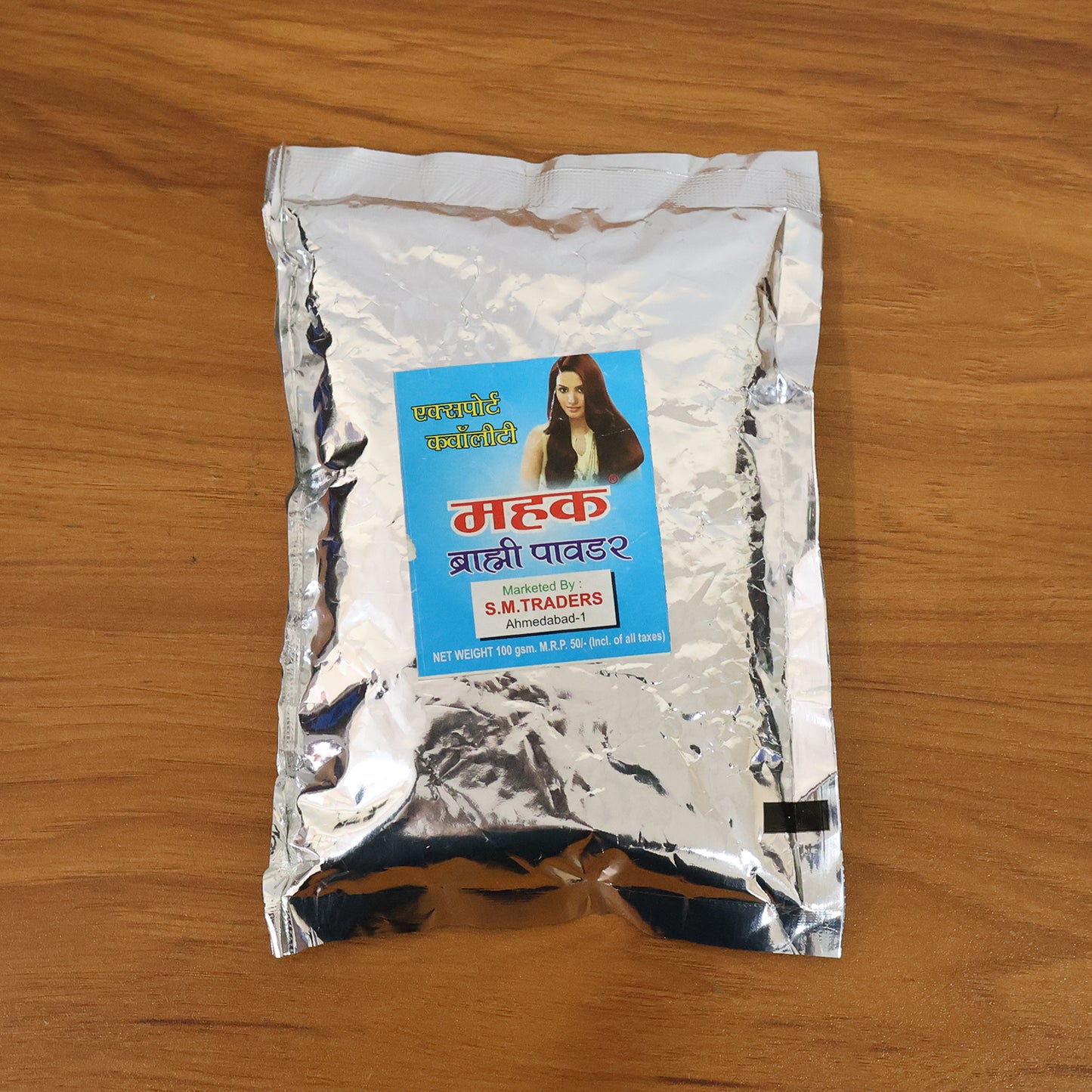 Wukusy Herbal Brahmi Powder in a 100 gram pack, showing fine green powder in a clear container with a white background.