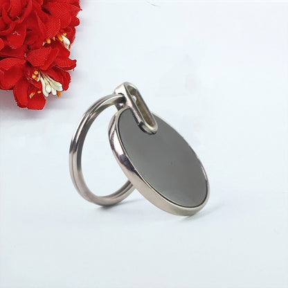 Black round metal keychain from Wukusy, sleek and minimalist design, featuring a smooth, polished finish.