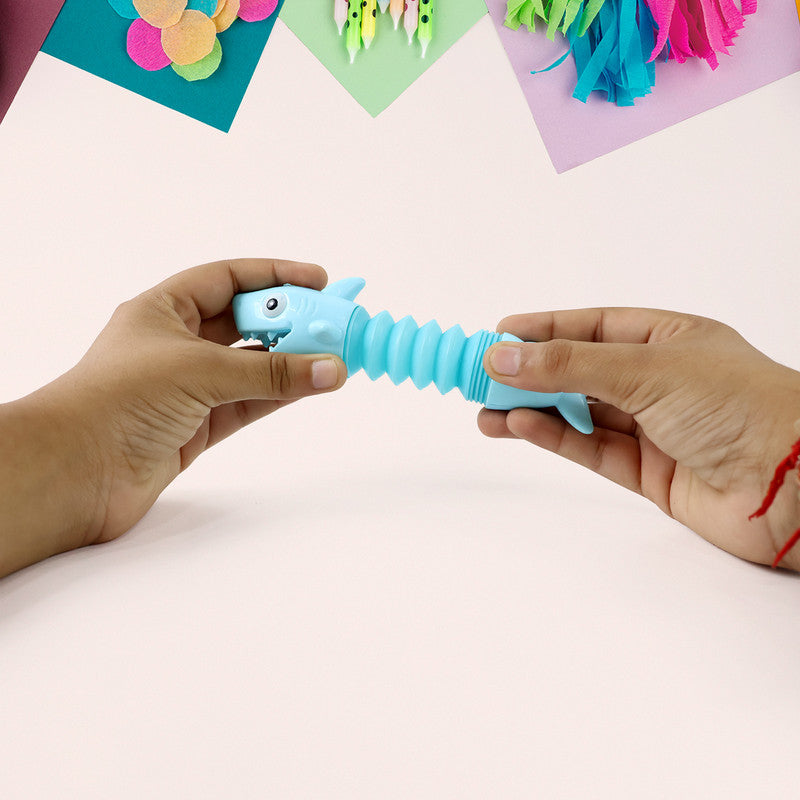 Shark shape magic spring toy by Wukusy, featuring a flexible, colorful plastic spring with a shark design for fun play.