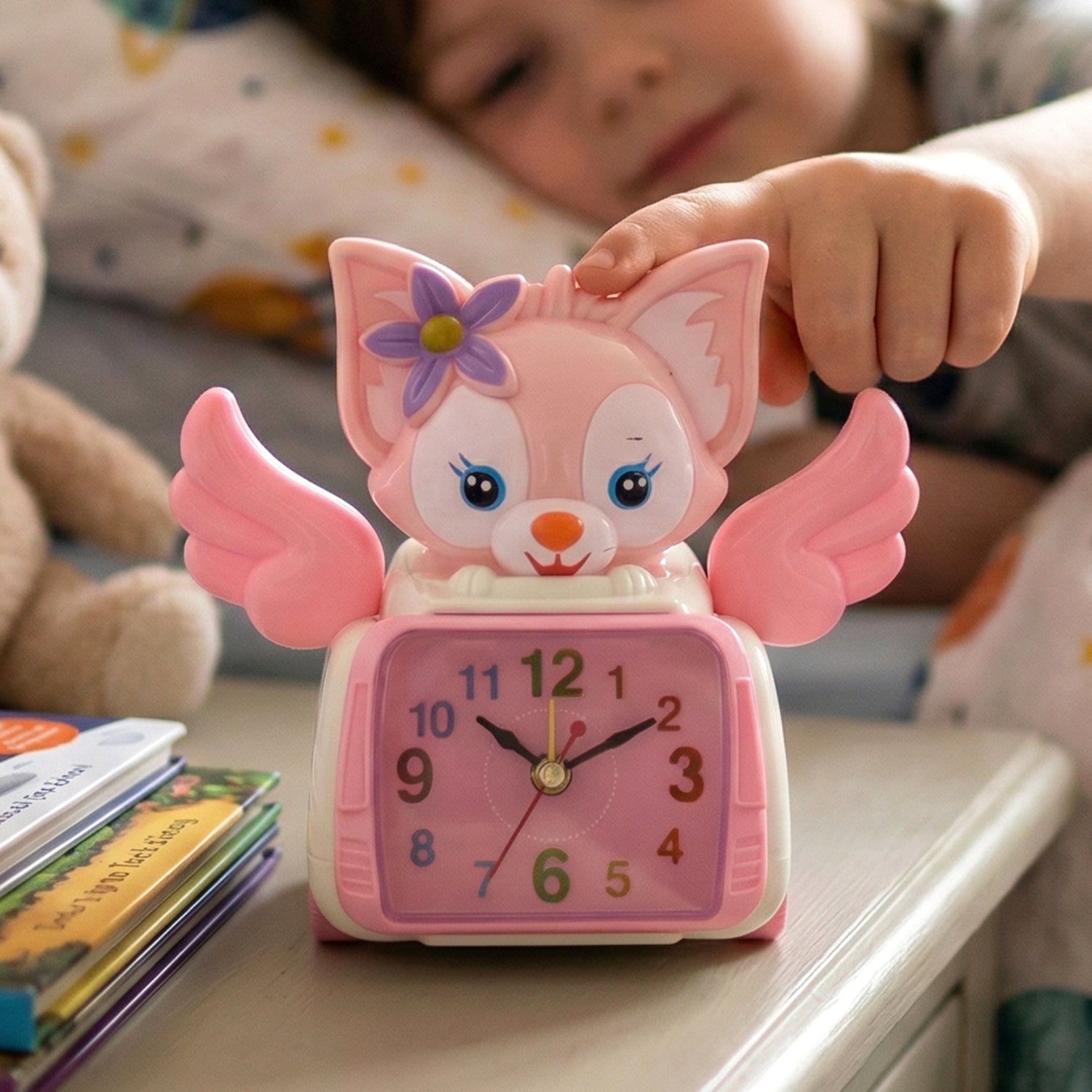Wukusy angel cat-themed kids alarm clock featuring a cute angel design with colorful details and playful appearance.