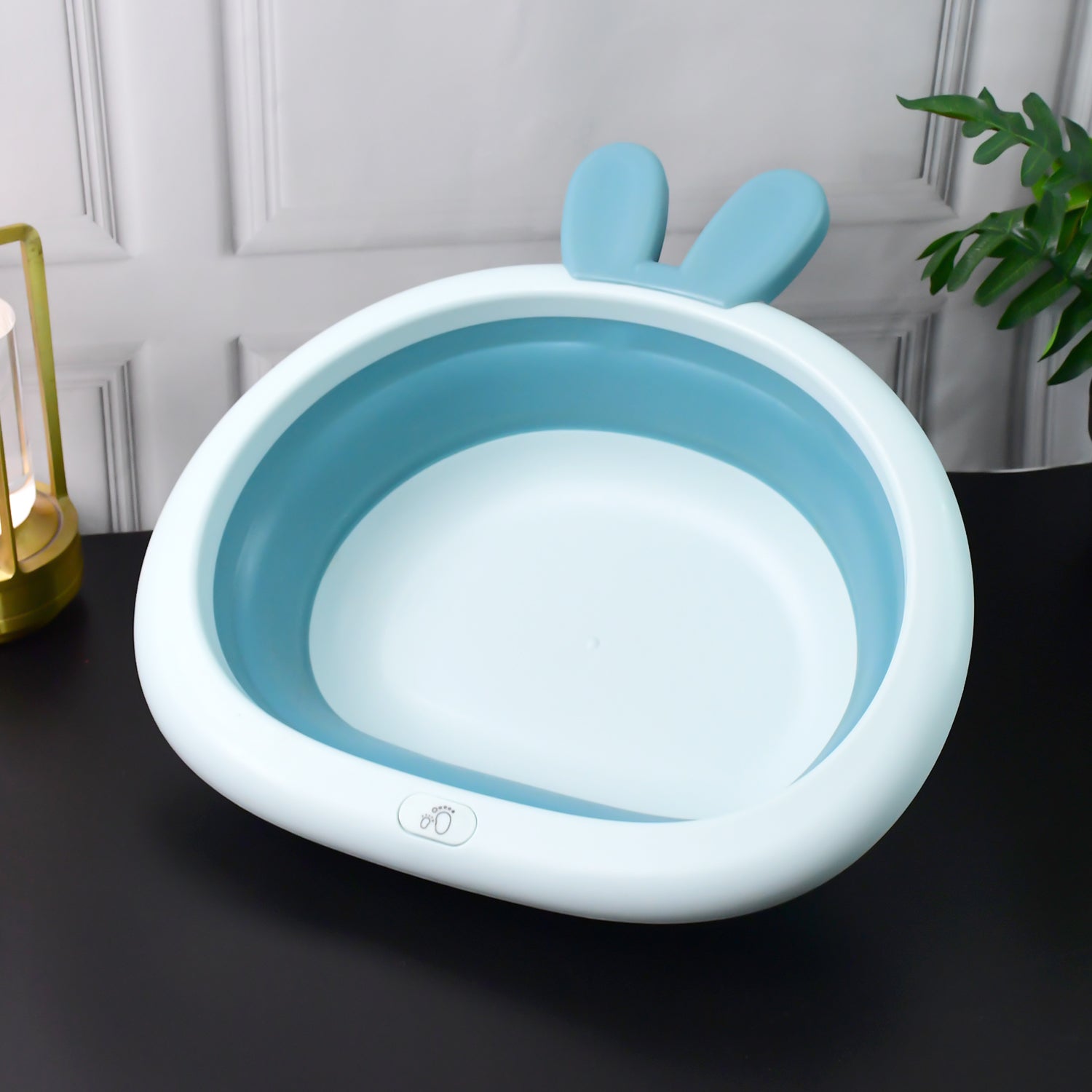 Foldable Wukusy baby care basin with bunny ear handle, collapsible design for easy storage and transport.
