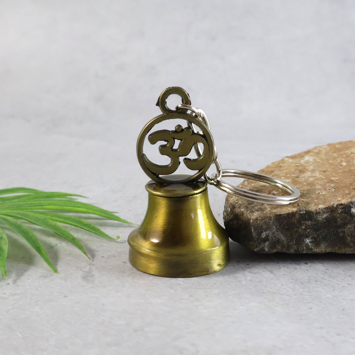 Wukusy Om Symbol temple bell metal keychain for travel, featuring a detailed Om design and durable metal construction.