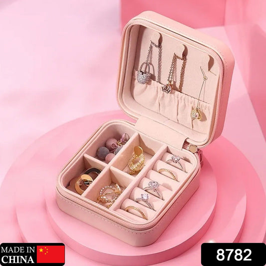 Wukusy mini leather jewelry box for women, portable organizer with compartments for rings, earrings, necklaces, and pendants.