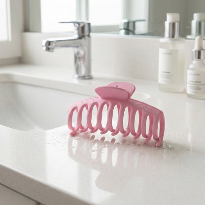 Wukusy elegant strong grip hair claw clip for women, shown holding hair in a stylish updo with a sleek black finish.