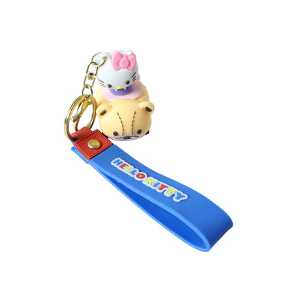 Cute cartoon cat riding toy car silicone keychain by Wukusy, featuring a playful cat figure on a small, colorful vehicle.