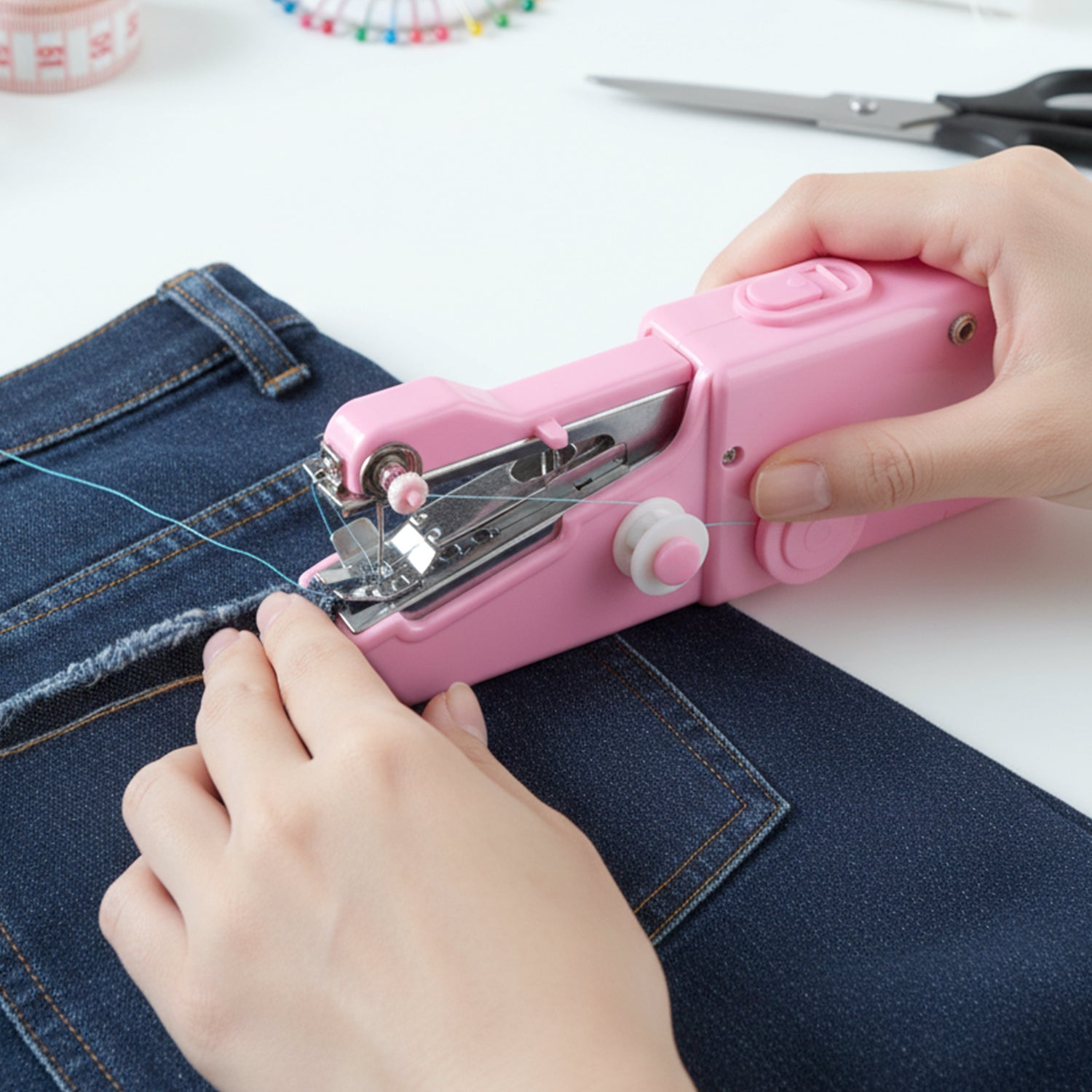 Portable Wukusy handheld sewing machine set with compact design, featuring a white and blue body and sewing accessories.