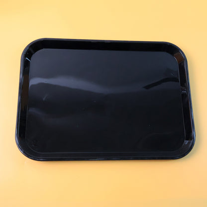 Black plastic serving tray plate, 40x30 cm, from Wukusy, shown with a smooth surface and raised edges for serving food.