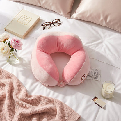 Soft plush pink and white U-shaped travel neck pillow by Wukusy, designed for head and neck support during travel.