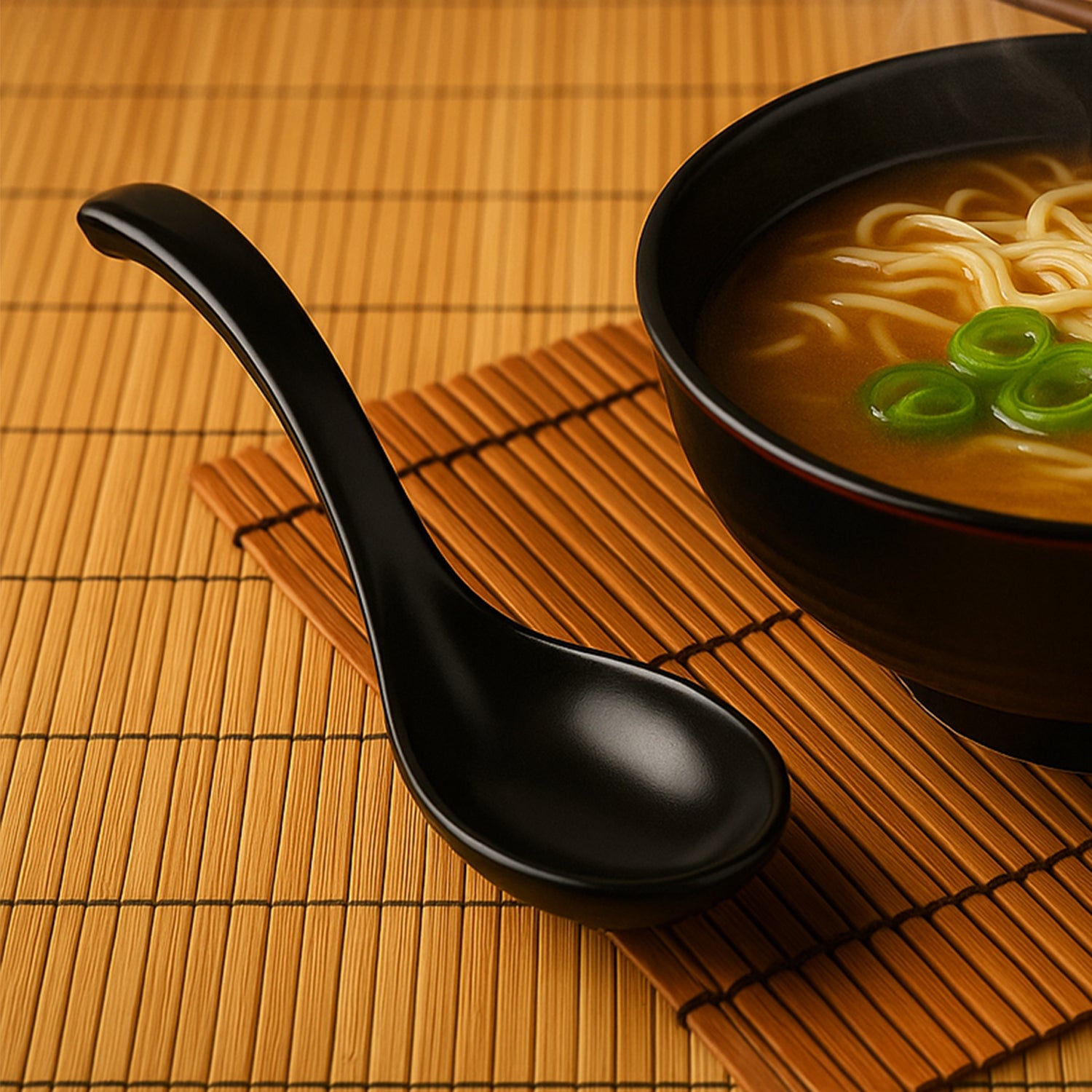 Black plastic soup spoon with deep bowl from Wukusy, ideal for home and kitchen use, shown in a close-up view.