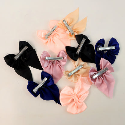 Set of 10 Wukusy satin bow hair clips for girls and women, featuring colorful, shiny satin bows on alligator clips.