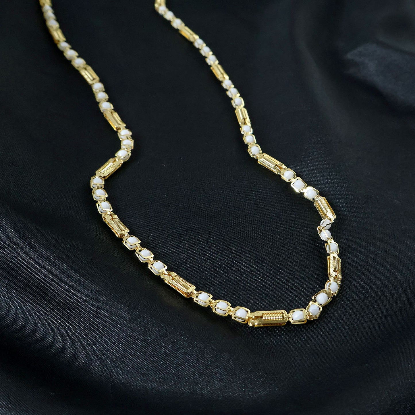 Gold-tone designer chain necklace by Wukusy featuring a sleek, stylish link design on a white background.